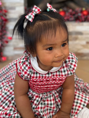Charlotte sy Dimby Christmas holiday tartan plaid handmade classic chic timeless traditional heirloom smocked dress for babies and girls. Elegant French style children’s clothing Paris boutique